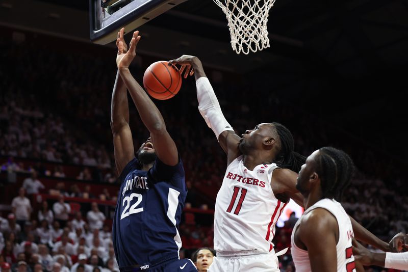 Jan 31, 2024; Piscataway, New Jersey, USA; Rutgers Scarlet Knights center Clifford Omoruyi (11) blocks a shot by Penn State Nittany Lions forward Qudus Wahab (22) during the first half at Jersey Mike's Arena. Mandatory Credit: Vincent Carchietta-USA TODAY Sports