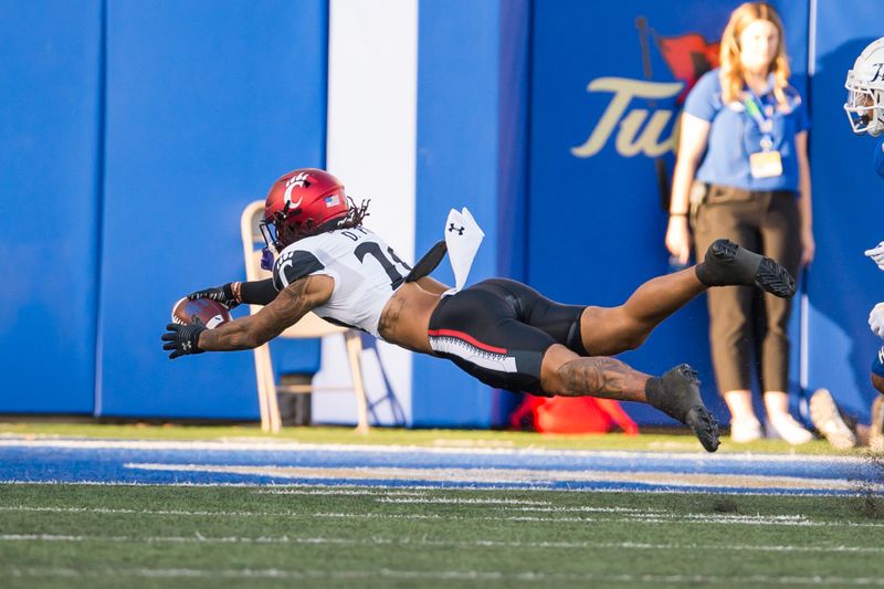 Oct 1, 2022; Tulsa, Oklahoma, USA;  Cincinnati Bearcats linebacker Deshawn Pace (20) dives for a touchdown after an interception during the first quarter against the Tulsa Golden Hurricane at Skelly Field at H.A. Chapman Stadium. Mandatory Credit: Brett Rojo-USA TODAY Sports