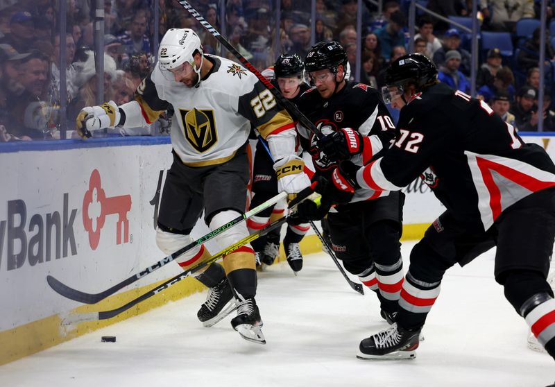 Mar 2, 2024; Buffalo, New York, USA;  Vegas Golden Knights right wing Michael Amadio (22) and Buffalo Sabres defenseman Henri Jokiharju (10) go after a loose puck during the first period at KeyBank Center. Mandatory Credit: Timothy T. Ludwig-USA TODAY Sports