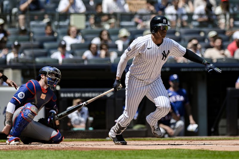 Aug 10, 2024; Bronx, New York, USA; New York Yankees outfielder Juan Soto (22) hits a single against the Texas Rangers during the first inning at Yankee Stadium. Mandatory Credit: John Jones-USA TODAY Sports