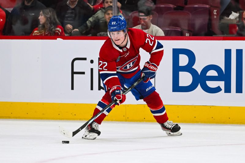 Dec 2, 2023; Montreal, Quebec, CAN; Montreal Canadiens right wing Cole Caufield (22) plays the puck against the Detroit Red Wings during the first period at Bell Centre. Mandatory Credit: David Kirouac-USA TODAY Sports