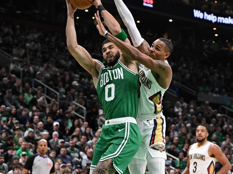 BOSTON, MASSACHUSETTS - JANUARY 12: Dejounte Murray #5 of the New Orleans Pelicans fouls Jayson Tatum #0 of the Boston Celtics during the second quarter at the TD Garden on January 12, 2025 in Boston, Massachusetts. NOTE TO USER: User expressly acknowledges and agrees that, by downloading and or using this photograph, User is consenting to the terms and conditions of the Getty Images License Agreement. (Photo by Brian Fluharty/Getty Images)