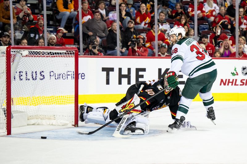 Nov 23, 2024; Calgary, Alberta, CAN; Minnesota Wild right wing Ryan Hartman (38) misses on a shootout against Calgary Flames goaltender Daniel Vladar (80) at Scotiabank Saddledome. Mandatory Credit: Brett Holmes-Imagn Images