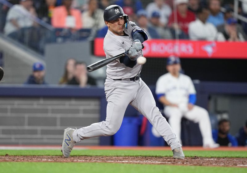 Apr 17, 2024; Toronto, Ontario, CAN; New York Yankees catcher Jose Trevino (39) hits an RBI single against the Toronto Blue Jays during the ninth inning at Rogers Centre. Mandatory Credit: Nick Turchiaro-USA TODAY Sports