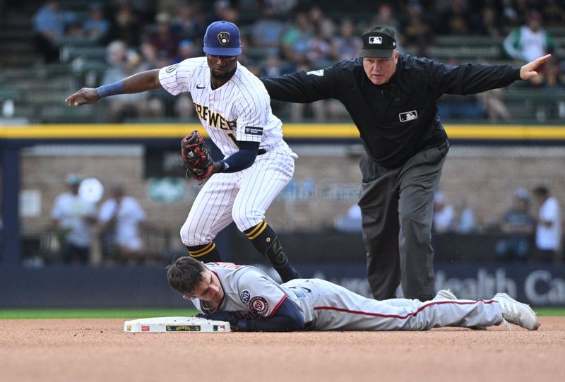 Sep 17, 2023; Milwaukee, Wisconsin, USA; Washington Nationals catcher Drew Millas (81) slides in safely ahead of the tag by Milwaukee Brewers second baseman Andruw Monasterio (14) in the eighth inning at American Family Field. Mandatory Credit: Michael McLoone-USA TODAY Sports