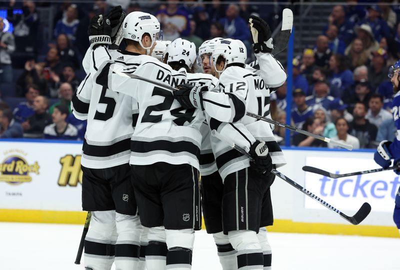 Jan 9, 2024; Tampa, Florida, USA; Los Angeles Kings center Phillip Danault (24) is congratulated after he scored a goal against the Tampa Bay Lightning during the second period at Amalie Arena. Mandatory Credit: Kim Klement Neitzel-USA TODAY Sports