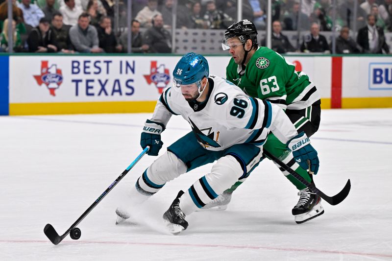 Nov 20, 2024; Dallas, Texas, USA; San Jose Sharks defenseman Jake Walman (96) keeps the puck away from Dallas Stars right wing Evgenii Dadonov (63) during the second period at the American Airlines Center. Mandatory Credit: Jerome Miron-Imagn Images