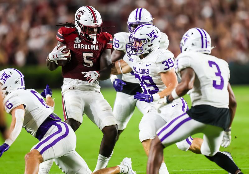 Sep 9, 2023; Columbia, South Carolina, USA; South Carolina Gamecocks running back Dakereon Joyner (5) attempted to rush past Furman Paladins linebacker Evan DiMaggio (39) during the first quarter at Williams-Brice Stadium. Mandatory Credit: Jeff Blake-USA TODAY Sports