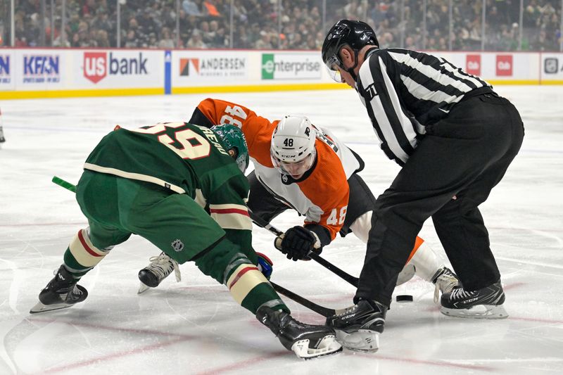 Jan 12, 2024; Saint Paul, Minnesota, USA; Philadelphia Flyers forward Morgan Frost (48) beats Minnesota Wild Center Frederick Gaudreau (89) on a face-off during the first period at Xcel Energy Center. Mandatory Credit: Nick Wosika-USA TODAY Sports