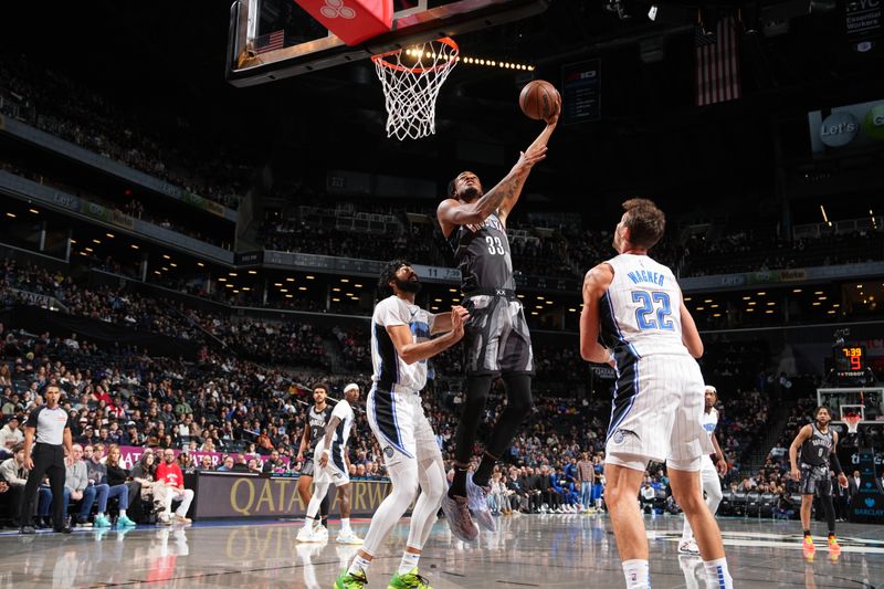 BROOKLYN, NY - DECEMBER 1: Nicolas Claxton #33 of the Brooklyn Nets drives to the basket during the game against the Orlando Magic on December 1, 2024 at Barclays Center in Brooklyn, New York. NOTE TO USER: User expressly acknowledges and agrees that, by downloading and or using this Photograph, user is consenting to the terms and conditions of the Getty Images License Agreement. Mandatory Copyright Notice: Copyright 2024 NBAE (Photo by Jesse D. Garrabrant/NBAE via Getty Images)