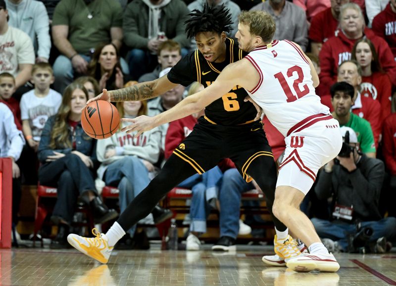 Jan 17, 2026; Bloomington, Indiana, USA; Indiana Hoosiers forward Tucker DeVries (12) knocks the ball away from Iowa Hawkeyes guard Tavion Banks (6) during the first half at Simon Skjodt Assembly Hall. Mandatory Credit: Robert Goddin-Imagn Images