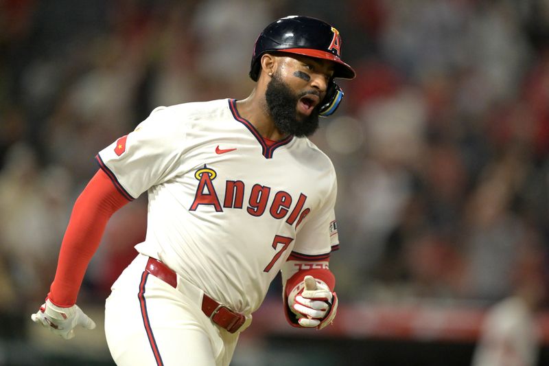 Jul 30, 2024; Anaheim, California, USA; Los Angeles Angels right fielder Jo Adell (7) celebrates as he rounds the bases after hitting a solo home run in the seventh inning against the Colorado Rockies at Angel Stadium. Mandatory Credit: Jayne Kamin-Oncea-USA TODAY Sports