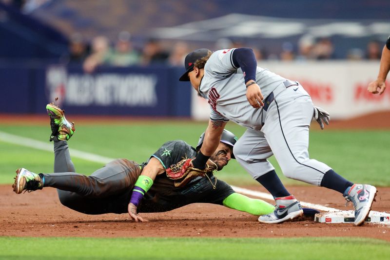 Jul 13, 2024; St. Petersburg, Florida, USA; Tampa Bay Rays shortstop Jose Caballero (7) is picked off by Cleveland Guardians first baseman Josh Naylor (22) in the second inning at Tropicana Field. Mandatory Credit: Nathan Ray Seebeck-USA TODAY Sports