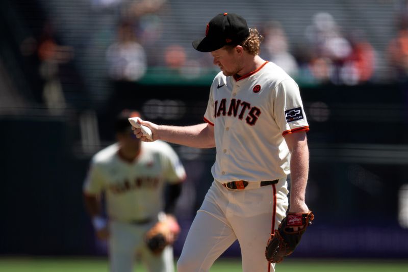 Aug 15, 2024; San Francisco, California, USA; San Francisco Giants starting pitcher Logan Webb (62) squeezes the rosin bag before facing the Atlanta Braves during the first inning at Oracle Park. Mandatory Credit: D. Ross Cameron-USA TODAY Sports