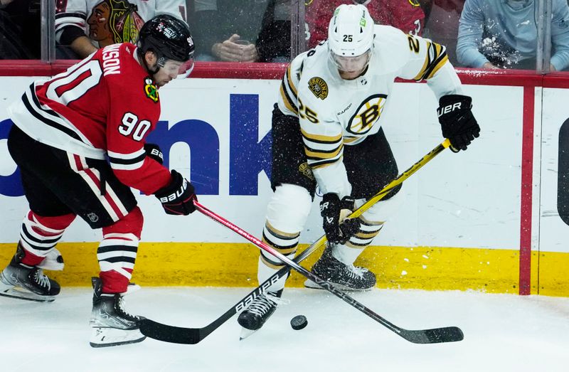 Oct 24, 2023; Chicago, Illinois, USA; Boston Bruins defenseman Brandon Carlo (25) and Chicago Blackhawks center Tyler Johnson (90) go for the puck during the second period at United Center. Mandatory Credit: David Banks-USA TODAY Sports