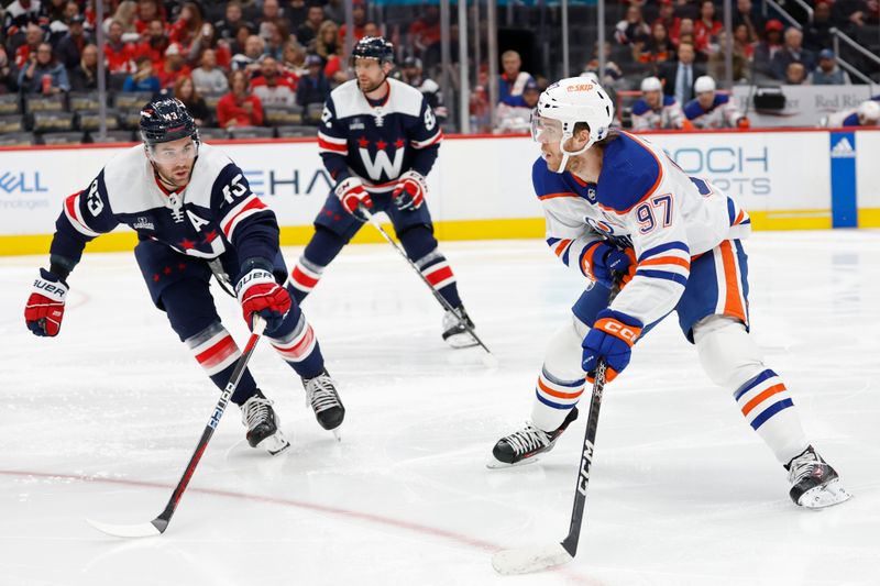 Nov 24, 2023; Washington, District of Columbia, USA; Edmonton Oilers center Connor McDavid (97) skates with the puck as Washington Capitals right wing Tom Wilson (43) defends in the second period at Capital One Arena. Mandatory Credit: Geoff Burke-USA TODAY Sports