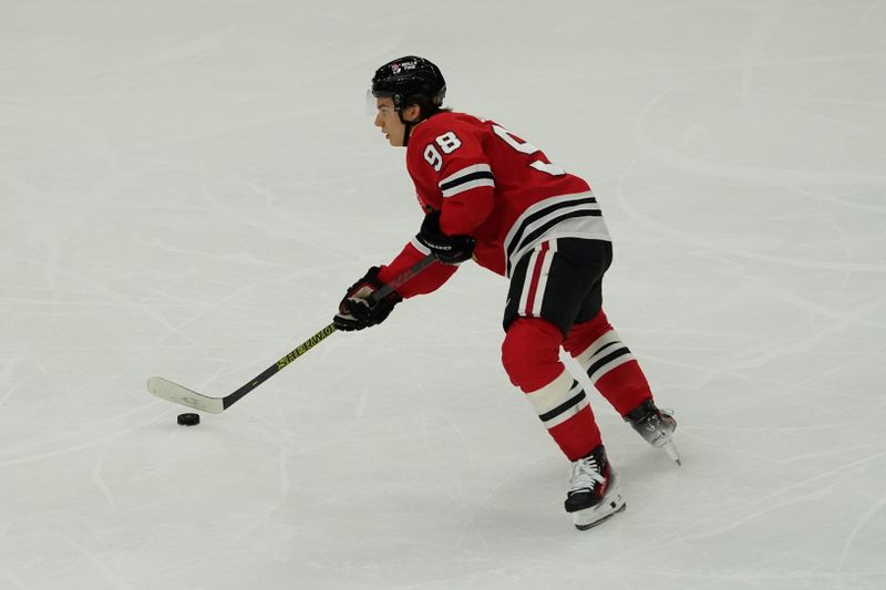 Oct 22, 2024; Chicago, Illinois, USA; Chicago Blackhawks center Connor Bedard (98) shoots the puck against the Vancouver Canucks during the first period at United Center. Mandatory Credit: David Banks-Imagn Images