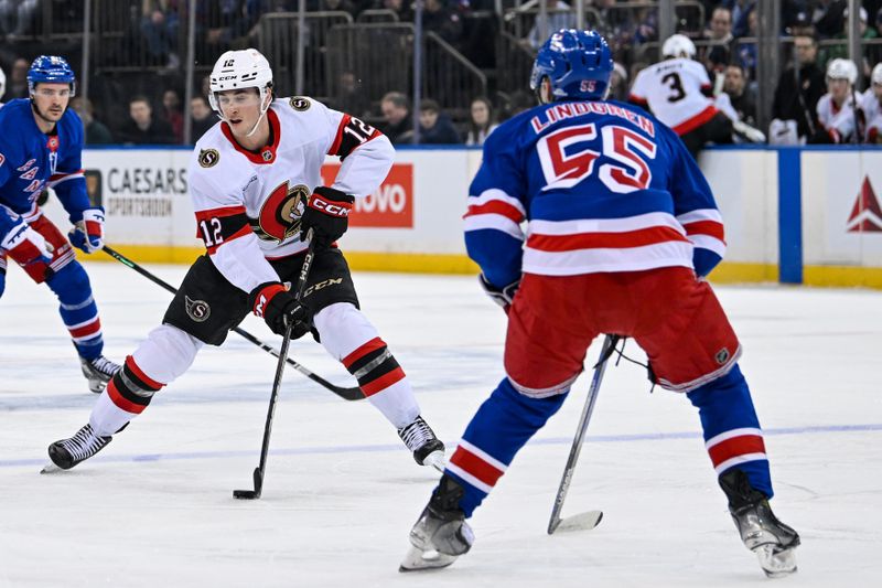 Jan 21, 2025; New York, New York, USA;  Ottawa Senators center Shane Pinto (12) skates with the puck defended by New York Rangers defenseman Ryan Lindgren (55) during the first period at Madison Square Garden. Mandatory Credit: Dennis Schneidler-Imagn Images