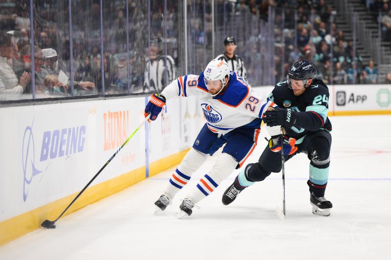 Oct 2, 2024; Seattle, Washington, USA; Edmonton Oilers center Leon Draisaitl (29) protects the puck from Seattle Kraken defenseman Jamie Oleksiak (24) during the second period at Climate Pledge Arena. Mandatory Credit: Steven Bisig-Imagn Images