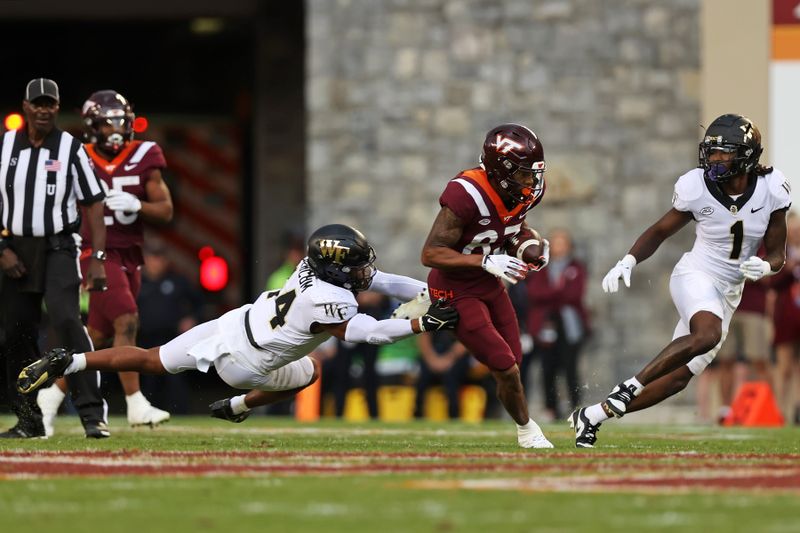 Oct 14, 2023; Blacksburg, Virginia, USA; Virginia Tech Hokies wide receiver Jaylin Lane (83) runs for a touchdown against Wake Forest Demon Deacons defensive lineman Justin Williams (44) and defensive back Caelen Carson (1) during the second quarter at Lane Stadium. Mandatory Credit: Peter Casey-USA TODAY Sports