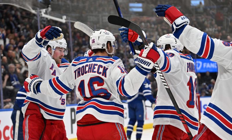 Mar 2, 2024; Toronto, Ontario, CAN; New York Rangers forward Vincent Trochek celebrates with teammates after scoring against the Toronto Maple Leafs in the second period at Scotiabank Arena. Mandatory Credit: Dan Hamilton-USA TODAY Sports