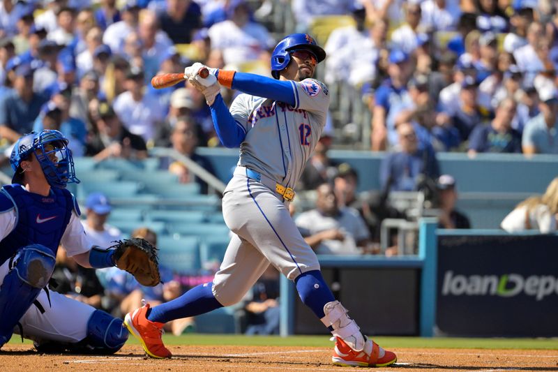 Oct 14, 2024; Los Angeles, California, USA; New York Mets shortstop Francisco Lindor (12) hits a solo home run in the first inning against the Los Angeles Dodgers during game two of the NLCS for the 2024 MLB Playoffs at Dodger Stadium. Mandatory Credit: Jayne Kamin-Oncea-Imagn Images