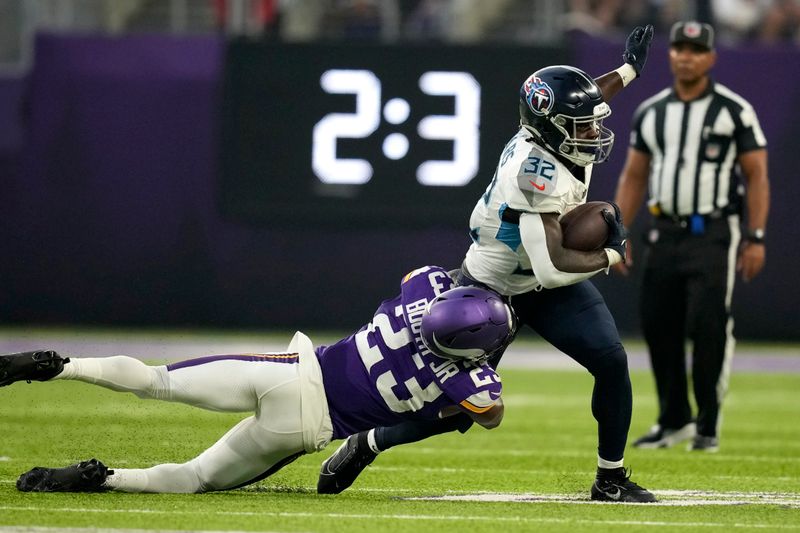 Tennessee Titans running back Tyjae Spears (32) breaks a tackle attempt by Minnesota Vikings cornerback Andrew Booth Jr. (23) as Spears runs the ball for a first down in the first half of a preseason NFL football game, Saturday, Aug. 19, 2023, in Minneapolis. (AP Photo/Charlie Neibergall)