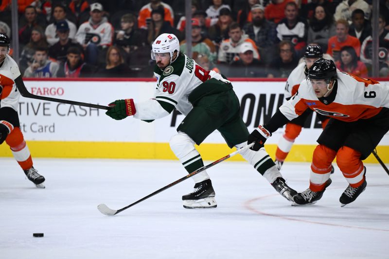 Oct 26, 2024; Philadelphia, Pennsylvania, USA; Minnesota Wild center Marcus Johansson (90) passes the puck against the Philadelphia Flyers in the second period at Wells Fargo Center. Mandatory Credit: Kyle Ross-Imagn Images