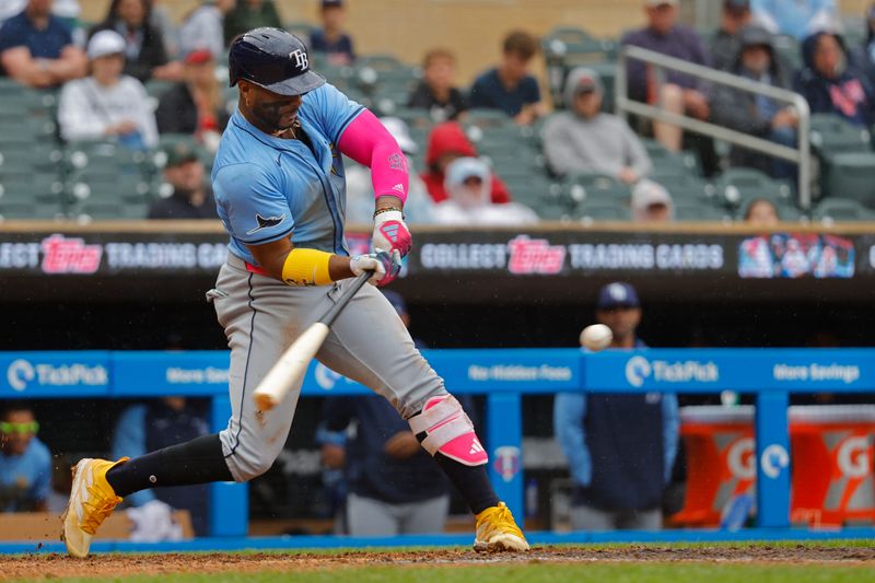 Jun 20, 2024; Minneapolis, Minnesota, USA; Tampa Bay Rays first baseman Yandy Diaz (2) hits a two-run home run against the Minnesota Twins in the ninth inning at Target Field. Mandatory Credit: Bruce Kluckhohn-USA TODAY Sports