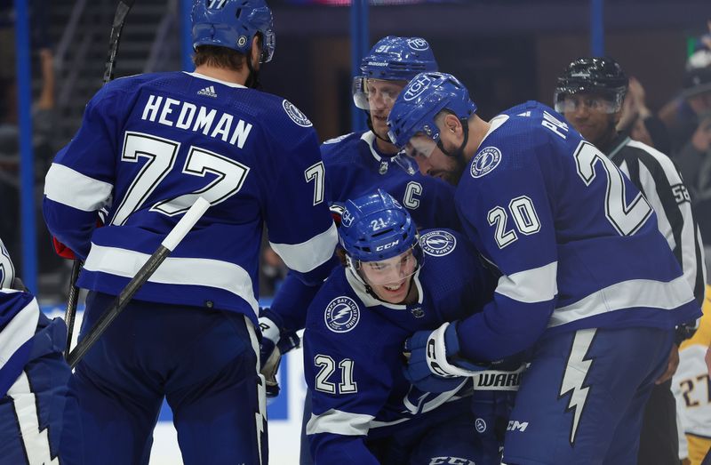 Oct 10, 2023; Tampa, Florida, USA; Tampa Bay Lightning left wing Nicholas Paul (20) is congratulated after he scored a goal on Nashville Predators goaltender Juuse Saros (74)  during the third period at Amalie Arena. Mandatory Credit: Kim Klement Neitzel-USA TODAY Sports