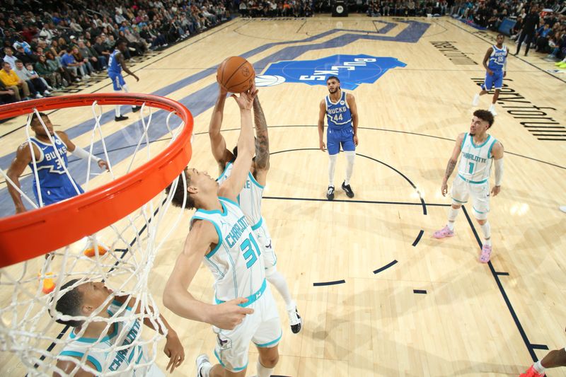 MILWAUKEE, WI - NOVEMBER 23: Tidjane Salaun #31 of the Charlotte Hornets assists the ball during the game against the Milwaukee Bucks on November 23, 2024 at the Fiserv Forum Center in Milwaukee, Wisconsin. NOTE TO USER: User expressly acknowledges and agrees that, by downloading and or using this Photograph, user is consenting to the terms and conditions of the Getty Images License Agreement. Mandatory Copyright Notice: Copyright 2023 NBAE (Photo by Gary Dineen/NBAE via Getty Images).