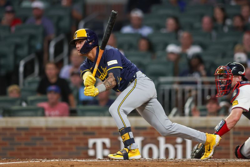 Aug 7, 2024; Atlanta, Georgia, USA; Milwaukee Brewers third baseman Joey Ortiz (3) hits a RBI single against the Atlanta Braves in the fifth inning at Truist Park. Mandatory Credit: Brett Davis-USA TODAY Sports