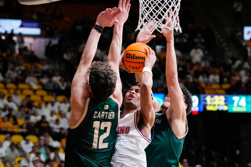 Jan 27, 2024; Laramie, Wyoming, USA; Wyoming Cowboys guard Sam Griffin (3) shoots against Colorado State Rams forward Patrick Cartier (12) during overtime at Arena-Auditorium. Mandatory Credit: Troy Babbitt-USA TODAY Sports