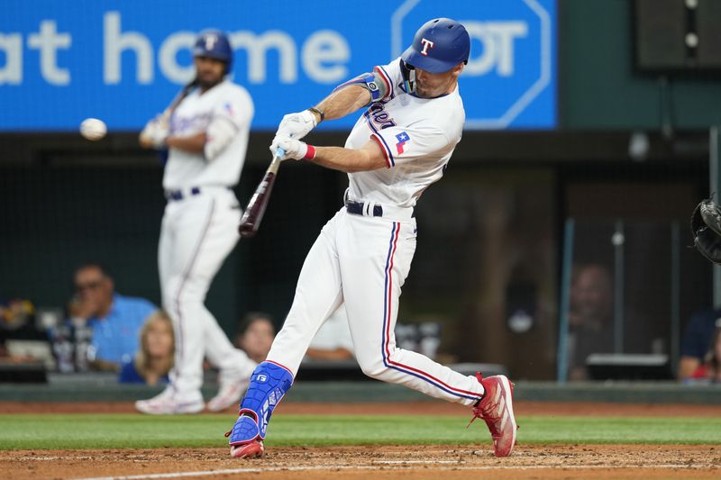 Sep 20, 2023; Arlington, Texas, USA; Texas Rangers center fielder Evan Carter (32) hits a double against the Boston Red Sox during the second inning at Globe Life Field. Mandatory Credit: Jim Cowsert-USA TODAY Sports