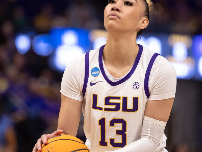 Mar 22, 2024; Baton Rouge, Louisiana, USA; LSU Lady Tigers guard Last-Tear Poa (13) shoots a free throw against the Rice Owls during the second half at Pete Maravich Assembly Center. Mandatory Credit: Stephen Lew-USA TODAY Sports