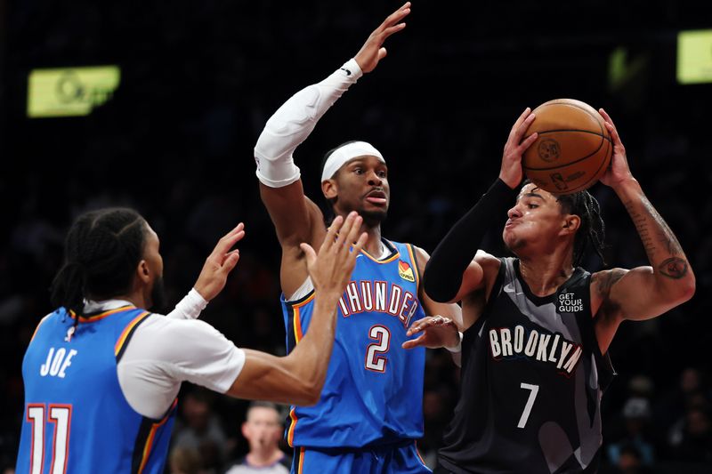 NEW YORK, NEW YORK - FEBRUARY 26: Killian Hayes #7 of the Brooklyn Nets looks to pass as Isaiah Joe #11 and Shai Gilgeous-Alexander #2 of the Oklahoma City Thunder defends during the second half at Barclays Center on February 26, 2025 in the Brooklyn borough of New York City. The Thunder won 129-121. NOTE TO USER: User expressly acknowledges and agrees that, by downloading and or using this photograph, User is consenting to the terms and conditions of the Getty Images License Agreement. (Photo by Sarah Stier/Getty Images)