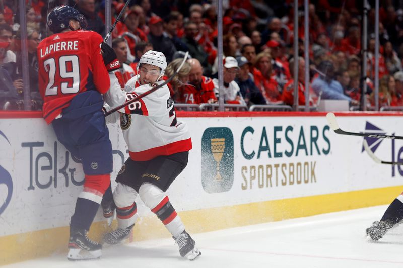 Feb 26, 2024; Washington, District of Columbia, USA; Ottawa Senators defenseman Erik Brannstrom (26) checks Washington Capitals center Hendrix Lapierre (29) in the second period at Capital One Arena. Mandatory Credit: Geoff Burke-USA TODAY Sports