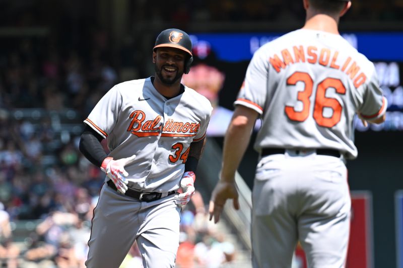 Jul 9, 2023; Minneapolis, Minnesota, USA; Baltimore Orioles designated hitter Aaron Hicks (34) and third base coach Tony Mansolino (36) react after Hicks hit a three-run home run off Minnesota Twins relief pitcher Jovani Moran (not pictured) during the fifth inning at Target Field. Mandatory Credit: Jeffrey Becker-USA TODAY Sports