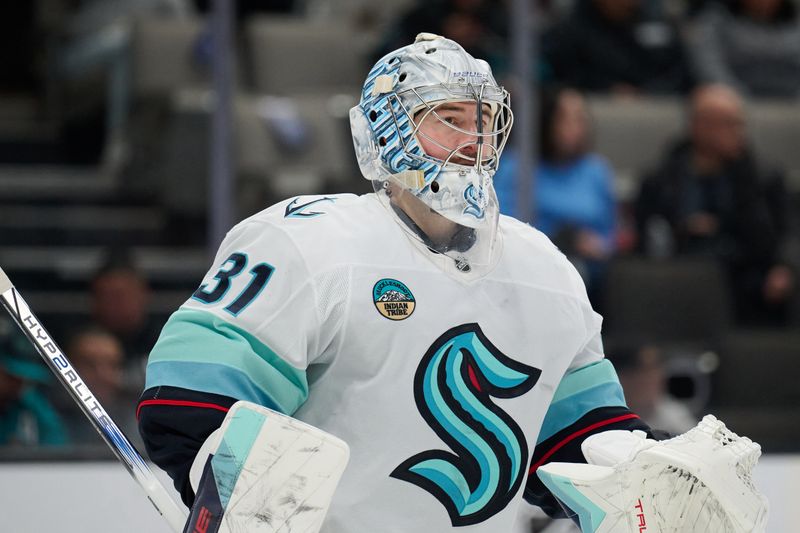 Nov 29, 2024; San Jose, California, USA; Seattle Kraken goaltender Philipp Grubauer (31) watches the play against the San Jose Sharks during the second period at SAP Center at San Jose. Mandatory Credit: Robert Edwards-Imagn Images