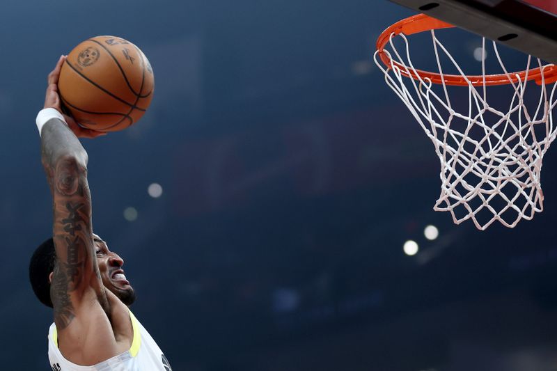 PORTLAND, OREGON - DECEMBER 06: John Collins #20 of the Utah Jazz dunks against the Portland Trail Blazers during the first half at Moda Center on December 06, 2024 in Portland, Oregon. NOTE TO USER: User expressly acknowledges and agrees that, by downloading and or using this photograph, User is consenting to the terms and conditions of the Getty Images License Agreement. (Photo by Steph Chambers/Getty Images)