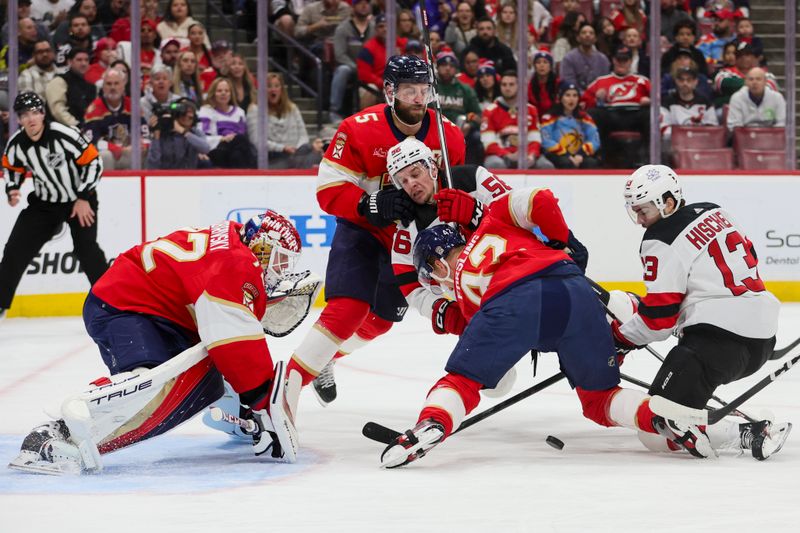 Jan 13, 2024; Sunrise, Florida, USA; Florida Panthers goaltender Sergei Bobrovsky (72), defenseman Aaron Ekblad (5) and defenseman Gustav Forsling (42) defend against New Jersey Devils left wing Erik Haula (56) and center Nico Hischier (13) at Amerant Bank Arena. Mandatory Credit: Sam Navarro-USA TODAY Sports