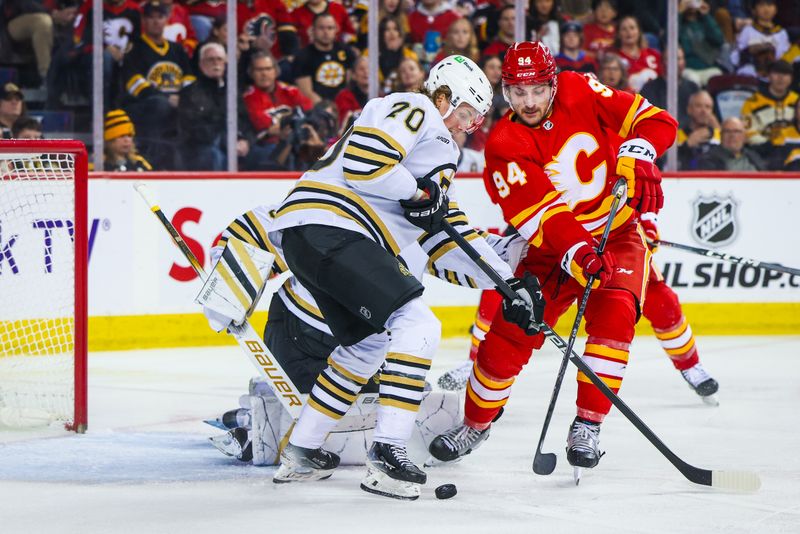 Feb 22, 2024; Calgary, Alberta, CAN; Boston Bruins goaltender Brandon Bussi (70) and Calgary Flames defenseman Brayden Pachal (94) battles for the puck during the second period at Scotiabank Saddledome. Mandatory Credit: Sergei Belski-USA TODAY Sports