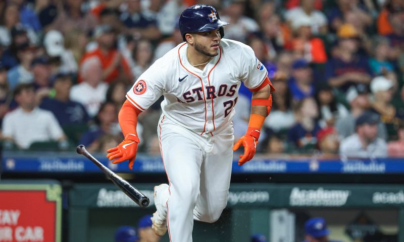 Apr 3, 2024; Houston, Texas, USA; Houston Astros catcher Yainer Diaz (21) hits a single during the fifth inning against the Toronto Blue Jays at Minute Maid Park. Mandatory Credit: Troy Taormina-USA TODAY Sports