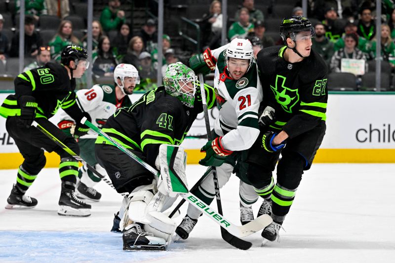 Jan 10, 2024; Dallas, Texas, USA; Minnesota Wild right wing Brandon Duhaime (21) skates between Dallas Stars goaltender Scott Wedgewood (41) and left wing Mason Marchment (27) during the first period at the American Airlines Center. Mandatory Credit: Jerome Miron-USA TODAY Sports