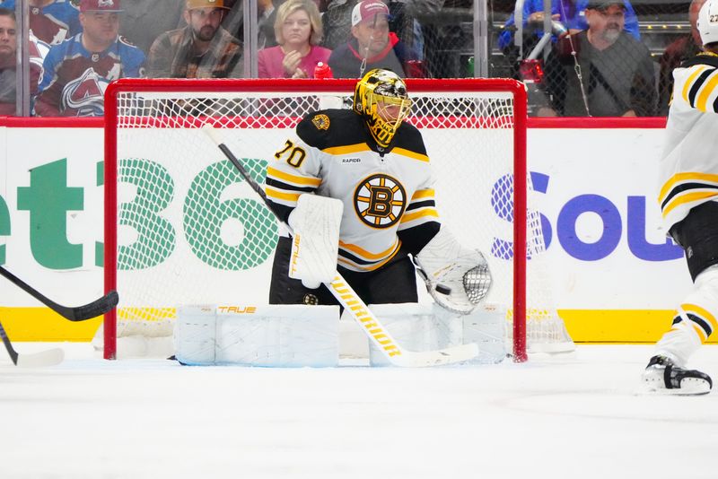 Oct 16, 2024; Denver, Colorado, USA; Boston Bruins goaltender Joonas Korpisalo (70) reaches for the puck in the third period against the Colorado Avalanche at Ball Arena. Mandatory Credit: Ron Chenoy-Imagn Images