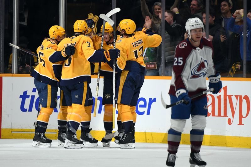 Mar 2, 2024; Nashville, Tennessee, USA; Nashville Predators center Cody Glass (8) is congratulated by teammates after a goal during the second period against the Colorado Avalanche at Bridgestone Arena. Mandatory Credit: Christopher Hanewinckel-USA TODAY Sports