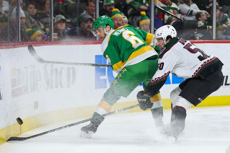 Jan 13, 2024; Saint Paul, Minnesota, USA; Minnesota Wild defenseman Dakota Mermis (6) passes as Arizona Coyotes defenseman Sean Durzi (50) defends during the second period at Xcel Energy Center. Mandatory Credit: Matt Krohn-USA TODAY Sports