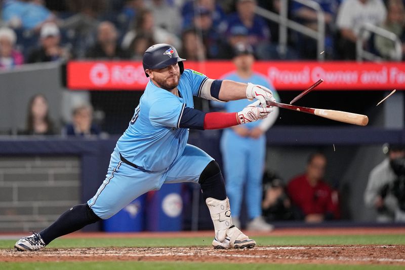 May 4, 2025; Toronto, Ontario, CAN; Toronto Blue Jays catcher Alejandro Kirk (30) breaks his bat as he hits a single against the Cleveland Guardians during the eighth inning at Rogers Centre. Mandatory Credit: John E. Sokolowski-Imagn Images