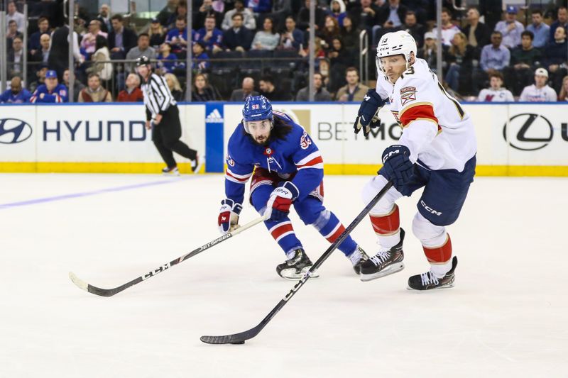 Mar 4, 2024; New York, New York, USA;  New York Rangers center Mika Zibanejad (93) and Florida Panthers center Sam Reinhart (13) chases the puck in the first period at Madison Square Garden. Mandatory Credit: Wendell Cruz-USA TODAY Sports