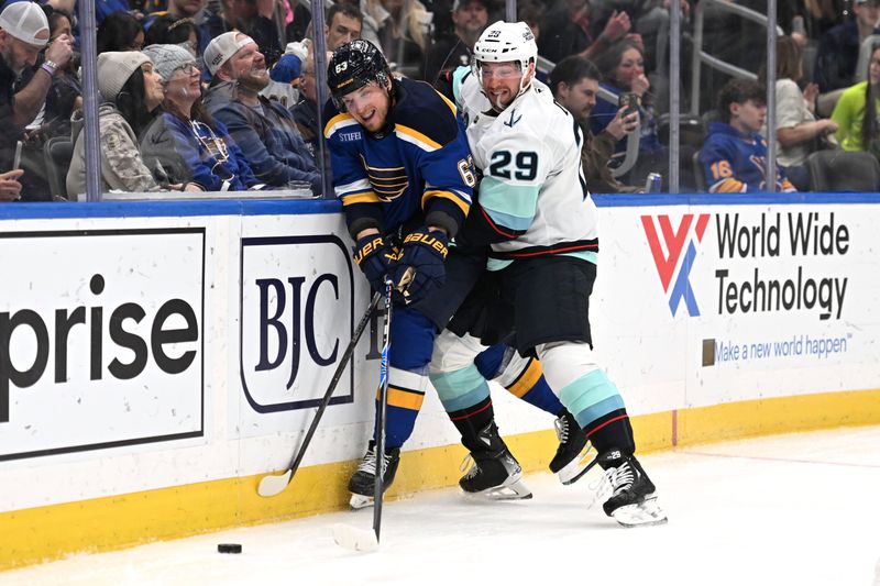 Feb 26, 2026; St. Louis, Missouri, USA; Seattle Kraken defenseman Vince Dunn (29) checks St. Louis Blues left wing Jake Neighbours (63) during the second period at Enterprise Center. Mandatory Credit: Joe Puetz-Imagn Images